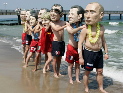 Activists of British charity organization Oxfam, wearing masks of the G8 heads of state, pose on the beach in Kuehlungsborn June 7, 2007. Leaders from the world's major industrialised nations meet in the Baltic resort of Heiligendamm on June 6-8 for a Group of Eight (G8) summit.