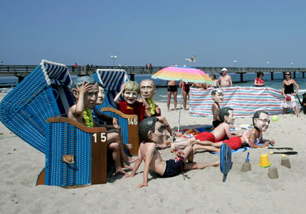 Activists of British charity organization Oxfam wearing masks of the G8 heads of state pose on the beach in Kuehlungsborn June 7, 2007. Leaders from the world's major industrialised nations meet in the Baltic resort of Heiligendamm on June 6-8 for a Group of Eight (G8) summit.