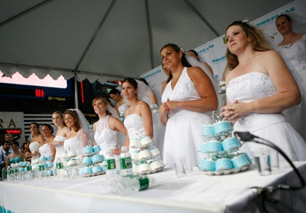 Contestants prepare to compete in the WE tv network's 'Bridezilla-Ultimate Cake Eating Contest' in New York's Times Square June 12, 2007. The cable channel gave away a $25,000 prize to kick off the fourth season of their 'Bridezillas' series.