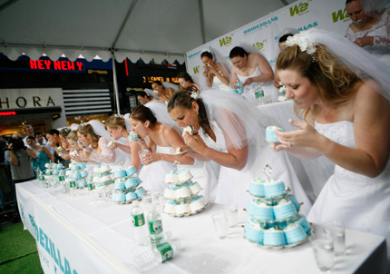 Contestants compete in the WE tv network's 'Bridezilla-Ultimate Cake Eating Contest' in New York's Times Square June 12, 2007. 
