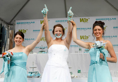 Stephanie Florio (C) celebrates winning the WE tv network's 'Bridezilla-Ultimate Cake Eating Contest' in New York's Times Square June 12, 2007. The cable channel gave away a $25,000 prize to kick off the fourth season of their 'Bridezillas' series.