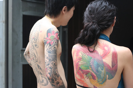 A man and a woman show their tattoos during the Tattoo Show Convention China 2007 in Beijing June 16, 2007.