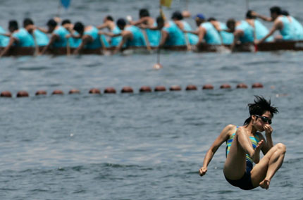 A girl jumps into the water during a dragon boat race in Stanley Bay in Hong Kong to mark the annual Tuen Ng or Dragon Boat Festival June 19, 2007.