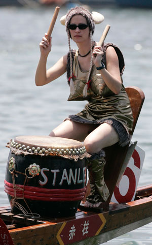 A woman participates in a dragon boat race at Stanley Bay in Hong Kong to mark the annual Tuen Ng or Dragon Boat Festival June 19, 2007.