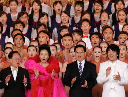 Chinese President Hu Jintao (1st row, 2nd R) and Hong Kong Chief Executive Donald Tsang (1st row, L) sing with performers and guests during the Grand Variety Show in Hong Kong June 30, 2007. The show is part of a series of events celebrating the 10th anniversary of Hong Kong's handover to China.