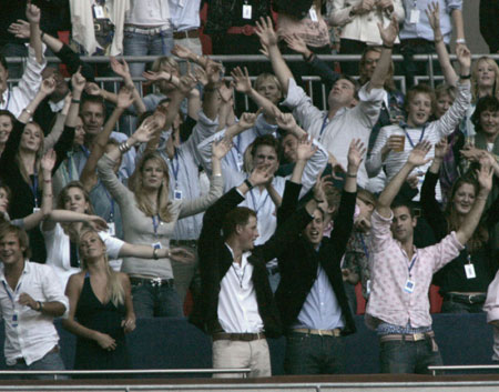 Princes William (2nd R) and Harry (C) and Harry's girlfriend Chelsey Davy (2nd L) wave at the Concert for Diana at Wembley Stadium in London July 1, 2007. Princess Diana's sons staged a charity concert in her memory on Sunday which they hope will quell her critics and celebrate her humanitarian achievements.
