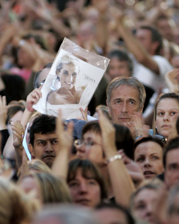 A member of the audience holds a portrait of Princess Diana at the Concert for Diana at Wembley Stadium in London July 1, 2007. An international lineup of pop stars paid tribute to Princess Diana on Sunday at a memorial concert watched by her sons Princes William and Harry and a crowd of 60,000 at London's Wembley Stadium.
