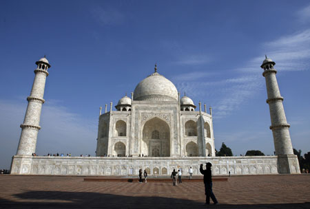 A visitor takes a picture near the Taj Mahal in the northern Indian city of Agra in this January 14, 2007 file photo. The Great Wall of China, Petra in Jordan and Brazil's statue of Christ the Redeemer have been chosen to be among the modern-day seven Wonders of the World, the organizers of the competition said on July 7, 2007.