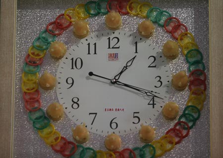 A clock decorated with condoms is seen at the 4th China Reproductive Health New Technologies & Products Expo in Beijing July 11, 2007. Condoms of all shapes and sizes were on show at a Beijing fashion show on Wednesday featuring dresses, hats and even lollipops made of the said item.