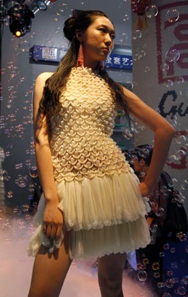 A model parades an outfit made of condoms during a fashion show at the 4th China Reproductive Health New Technologies & Products Expo in Beijing July 11, 2007. Condoms of all shapes and sizes were on show at a Beijing fashion show on Wednesday featuring dresses, hats and even lollipops made of the said item.