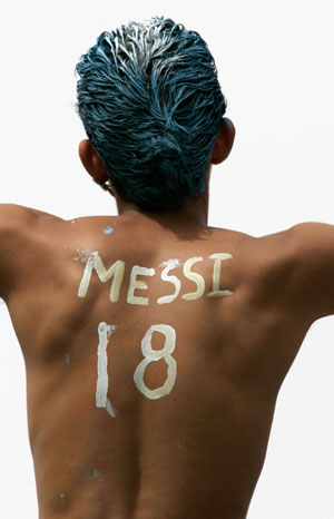 An Argentina fan's back is painted with the words: 