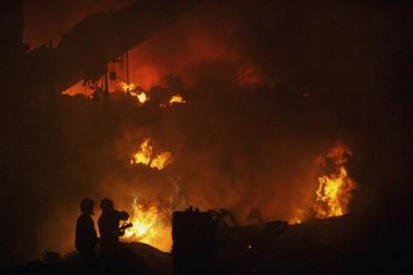 A fuel station burns after a Brazilian passenger plane crashed at Sao Paulo's Congonhas airport July 17, 2007. A Brazilian passenger plane carrying 176 people crashed into a fuel station and set off a huge fire at Sao Paulo's Congonhas airport on Tuesday, killing at least one person. 