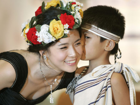 A child gives a kiss to South Korea actress Lee Bo-young at a news conference where she promoted her new TV drama series 