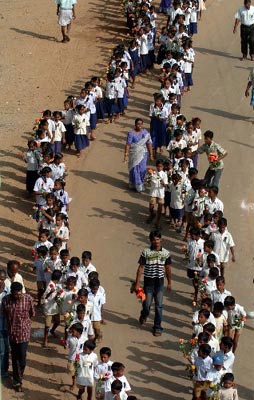 Students hold flowers to attend a march in commemoration of victims of Indian Ocean tsunami two years ago, in Nagappattinam district, the tsunami hard-hit region, of south Indian state Tamil Naduof on Dec. 26, 2006.