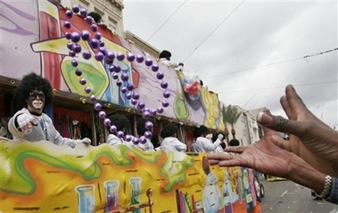 Beads are tossed at outstretched hands during the Zulu parade on Mardi Gras in New Orleans Tuesday, Feb. 20, 2007. 
