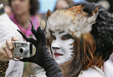 Kristina Rochelle Steinke takes a picture during Mardi Gras celebrations in the French Quarter of New Orleans, Tuesday, Feb. 20, 2007.