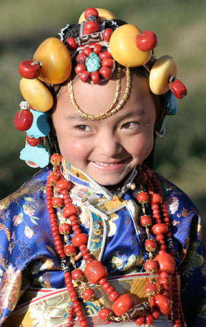 A child wears traditional costume during the Tibetan Kangba Art Festival in Yushu county, northwest China's Qinghai province July 25, 2007. The five-day art festival provides visitors with folk performances, costume displays and horse racings, local media reported. Picture taken July 25, 2007.