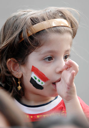 A soccer fan with the colours of an Iraqi flag painted on her face waits for the final match at the 2007 AFC Asian Cup soccer tournament at the Gelora Bung Karno stadium in Jakarta July 29, 2007.