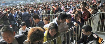 Travellers queue for tickets at Guangzhou railway station