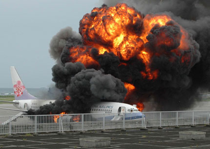 An airplane belonging to China Airlines Ltd from Taiwan Province bursts into flames after an explosion in Naha on Japan's southern island of Okinawa August 20, 2007. All 165 people on board had escaped safely, officials said.