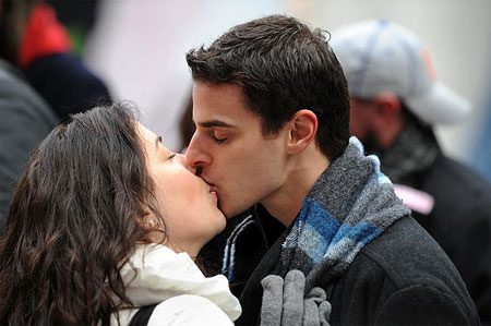 Couples practice kissing for New Year's Eve celebration