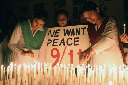 Pakistani students light candles in Multan September 11, 2006 to commemorate the fifth year anniversary of the September 11, 2001 attacks on the United States.