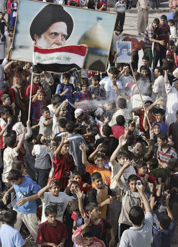 Residents take to the streets to celebrate the verdict against former Iraqi leader Saddam Hussein in Baghdad's Sadr city, November 5, 2006. Saddam was found guilty on Sunday of crimes against humanity and sentenced to hang in a case involving the deaths of more than 148 Shi'ite men from the town of Dujail.
