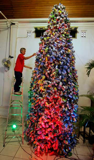 A man adds the finishing touches to a six-metre high Christmas tree made out of 6000 used cans at a church in Jakarta December 23, 2006. Jakarta plans to deploy about 18,000 police and 2,000 soldiers across the capital and its outskirts ahead of Christmas, a senior official said.