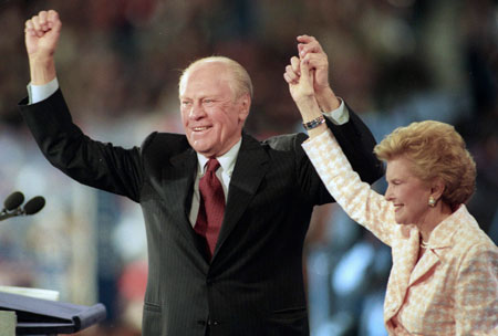 Former President Gerald Ford holds up the hand of his wife, Betty, as they acknowledge the crowd following his address at the evening session of the Republican National Convention in San Diego in this August 12, 1996 file photo. Ford, the 38th U.S. President, died at his home in California on Tuesday at age 93.