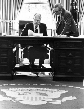 Former U.S. President Gerald Ford (L) works on a speech before a joint session of Congress, with Counsellor Robert Hartman in the White House Oval Office, in this August 12, 1974 file photo. Ford, the oldest living U.S. president at 93, died on December 26, 2006.