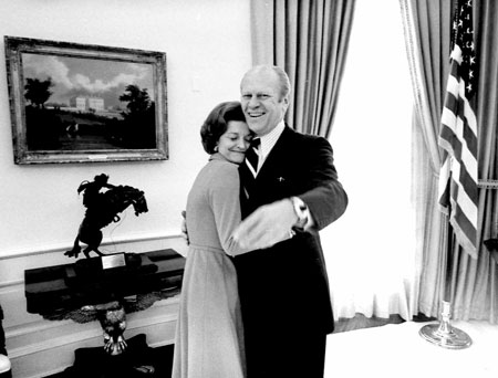 Former U.S. President Gerald Ford embraces his wife, former first lady Betty Ford, in the White House Oval Office, in this December 6, 1974 file photo. Ford, the oldest living U.S. president at 93, died on December 26, 2006.