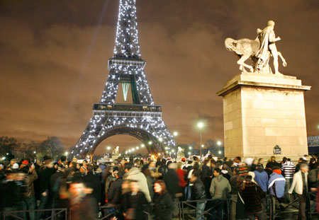Spectators gather in front of the Eiffel tower during New Year celebrations January 1, 2007.