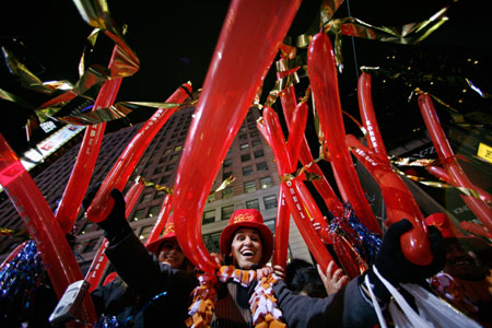 Revelers participate in New Year celebrations in Times Square in New York December 31, 2006. Huge crowds braved tight security and cold, rainy weather to usher in New Year's on Sunday in celebrations at New York's Times Square marked by the return of veteran television host Dick Clark.