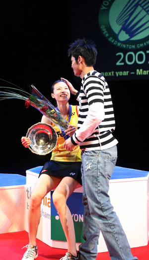 China's Xie Xingfang talks with China's Lin Dan after beating France's Pi Hongyan in the women's singles final at the All England badminton championships in Birmingham, England March 11, 2007.