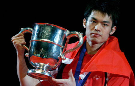 China's Lin Dan holds up the trophy after beating China's Chen Yu in the men's single final match at the All England badminton championships in Birmingham, England March 11, 2007.