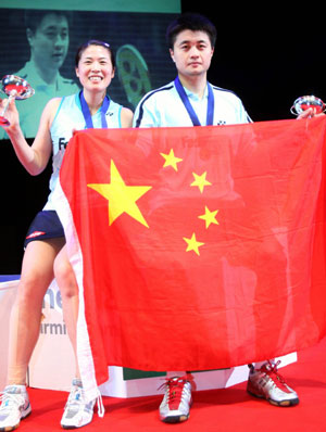 China's Zheng Bo and Gao Ling celebrate after beating England's Anthony Clark and Donna Kellogg in the mixed doubles final at the All England badminton championships in Birmingham, England March 11, 2007.