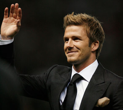 David Beckham waves to fans during the half-time break in a celebration soccer match between Manchester United and an Europe XI to mark the 50th anniversary of Manchester United appearing in European competition at Old Trafford in Manchester, northern England, March 13, 2007.