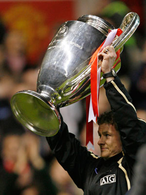 Manchester United's Ole Gunnar Solskjaer lifts the Champions League trophy before a celebration soccer match between Manchester United and team of players from Europe to mark the 50th anniversary of Manchester United appearing in European competition at Old Trafford in Manchester, northern England, March 13, 2007.