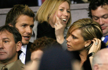 David Beckham talks to his wife Victoria (R) before a celebration soccer match between Manchester United and team of players from Europe to mark the 50th anniversary of Manchester United appearing in European competition at Old Trafford in Manchester, northern England, March 13, 2007.