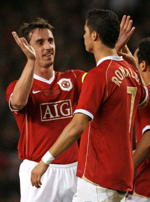 Manchester United's Cristiano Ronaldo celebrates with Gary Neville (L) after scoring against Europe XI during a celebration soccer match to mark the 50th anniversary of Manchester United appearing in European competition, at Old Trafford in Manchester, northern England, March 13, 2007.
