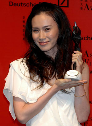 Japanese actress Miki Nakatani holds her trophy after winning the best actress award at the Asian Film Awards, a part of the Entertainment Expo Hong Kong, in Hong Kong March 20, 2007.