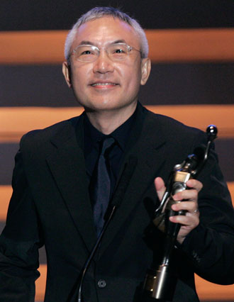 Director Patrick Tam Ka Ming holds the trophy of the Best Director Award for the movie 
