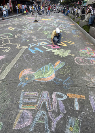 People use chalk to draw on a street during celebrations to mark Earth day in Baguio, north of Manila April 22, 2007.