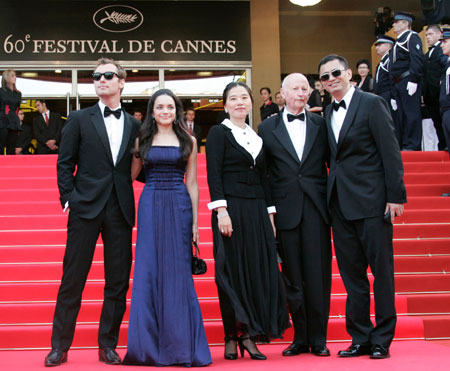 Chinese director Wong Kar Wai (R) is greeted by festival president Gilles Jacob (2nd R) as he arrives with his wife Esther (C) and cast members Jude Law (L) and Norah Jones for an evening gala screening of their in-competition film 
