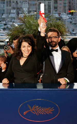 Directors Marjane Satrapi (L) of Iran and Vincent Paronnaud of France hold the Jury Prize for their film 
