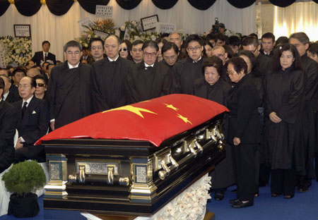 Late billionaire tycoon Henry Fok Ying-tung's family and relatives pay their last respects behind Fok's casket during his funeral in Hong Kong November 7, 2006.