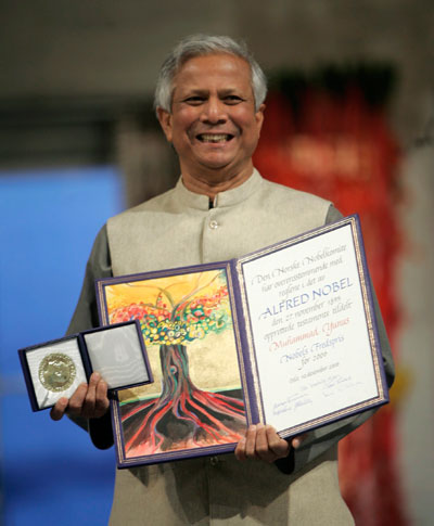 Nobel Peace Prize laureate Muhammad Yunus poses for photos with the Nobel medal and diploma during the award ceremony at Oslo Town Hall December 10, 2006. Bangladeshi economist Muhammad Yunus and the Grameen Bank that he founded received the Nobel Peace Prize on Sunday for their work to lift millions out of poverty by granting tiny loans to the poorest of the poor.