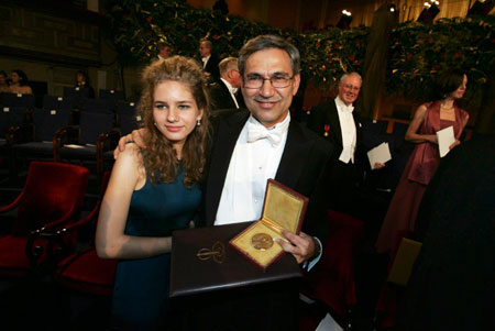 Nobel laureate for literature Orhan Pamuk of Turkey holds his medal as he poses with daughter Ryya after the prize ceremony in Stockholm December 10, 2006.