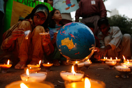 Pakistani students light candles to mark Earth Day in Karachi April 22, 2007. 