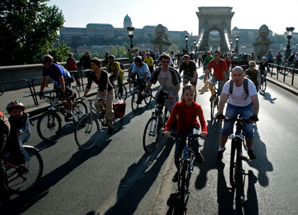 Cyclists ride across the Chain Bridge during a Critical Mass ride to celebrate Earth Day in Budapest April 22, 2007. Critical Mass is a cycling event in which a large number of cyclists ride on the streets. 